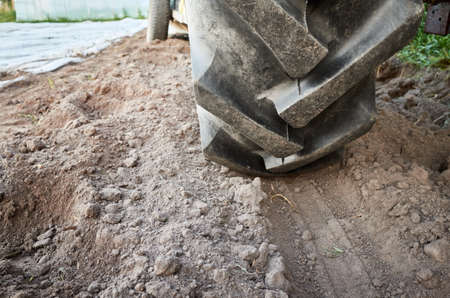 Close up picture of a tractor tire on the ground, selective focus.の写真素材