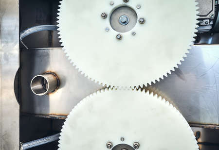 Close up of two plastic meshing gears transmitting rotational motion of a machine.の写真素材