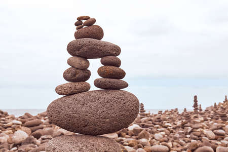 Stone stack on a beach, color toning applied, selective focus.の写真素材