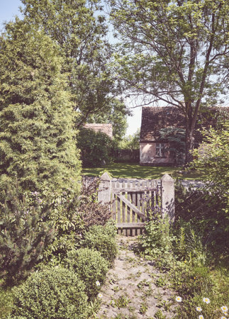 Retro toned rural view with an old wooden wicket.