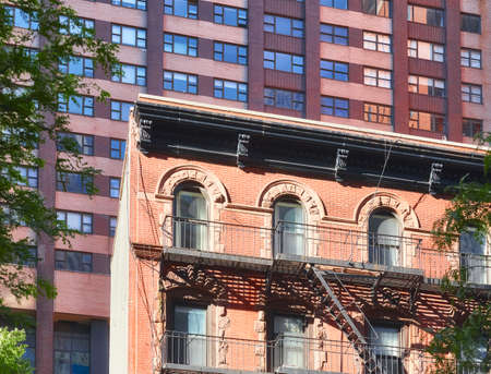 Old building with iron fire escape in Manhattan, New York City, USA.