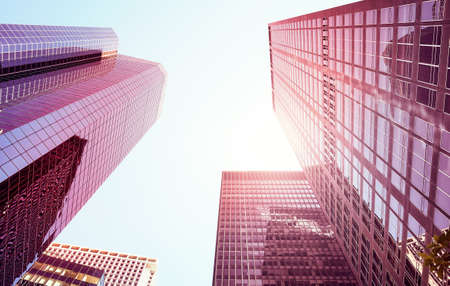 Looking up at Manhattan skyscrapers against the sun, color toned picture, New York City, USA.の写真素材
