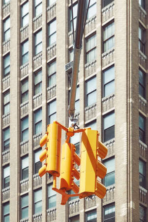Traffic lights in New York City with high rise building in background, color toning applied, USA.
