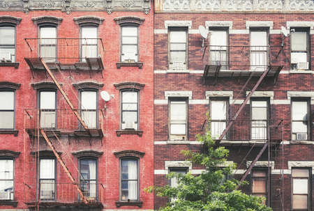 Old buildings with iron fire escapes, color toned picture, New York City, USA.