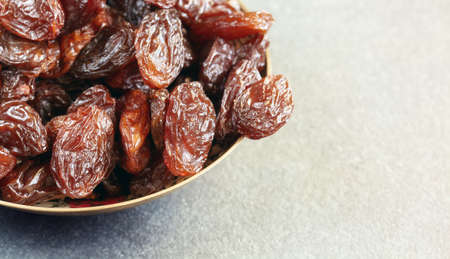 Close up picture of jumbo raisins in a bowl, selective focus.の写真素材