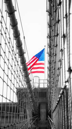 American flag on the top of Brooklyn Bridge, color toning applied, New York City, USA.の写真素材