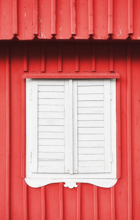 White wooden shutter on a red wall.の写真素材