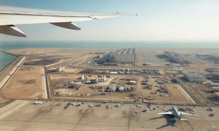 Wing of a plane above an airport, transport industry concept.の写真素材