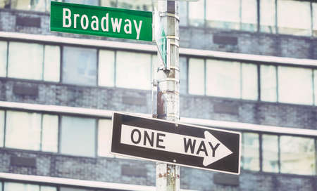 One Way traffic sign at Broadway road, color toning applied, selective focus, New York City, USA.