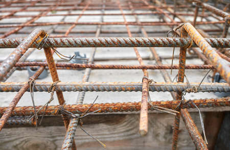 Close up picture of ribbed steel bar reinforcement construction ready for concrete casting, selective focus.の写真素材