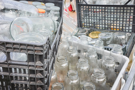 Used empty glass bottles stored in containers for recycling, selective focus.の写真素材