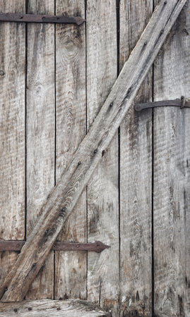 Close up photo of old wooden barn door, background or wallpaper.の写真素材