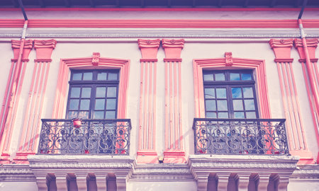 Street view of an old colonial building facade in Quito, color toning applied, Ecuador.の写真素材