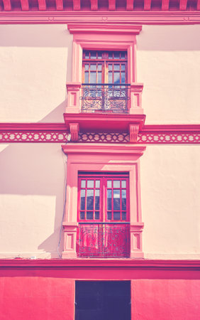 Street view of an old colonial building facade in Quito, color toning applied, Ecuador.