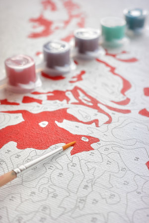 Painting by numbers, close up picture of a brush on canvas, selective focus.の写真素材