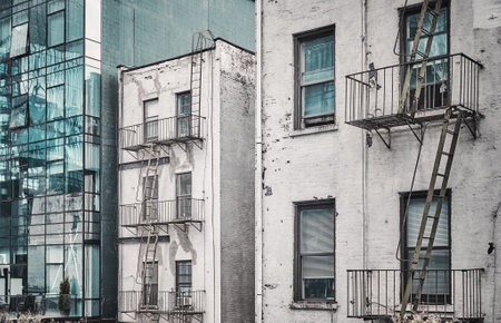 Old buildings with fire escapes, color toning applied, New York City, USA.の写真素材