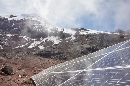 Photovoltaic panels with the Chimborazo volcano in the background, selective focus, Ecuador.