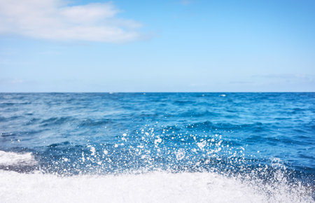 Blurred photo of sky and sea with splashing water, travel background.の写真素材