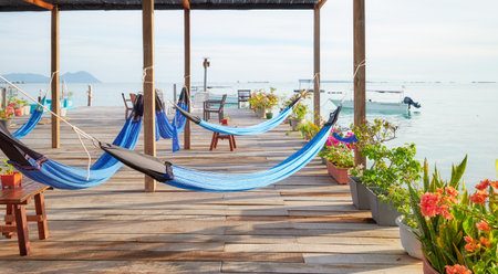 Hammocks on a wooden platform over water, holiday relaxation concept, Semporna district, Borneo, Malaysia.の写真素材