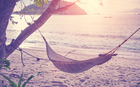 Hammock on the beach of a tropical island, color toning applied, Philippines.の写真素材