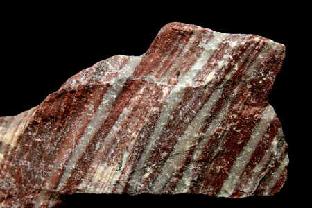 Red layered rock on black backgroundの写真素材