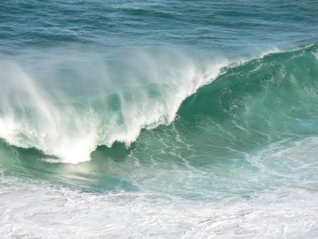A winter wave crashes powerfully onto the shore.の写真素材
