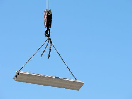 Close up of a crane hook lifting a heavy load.の写真素材