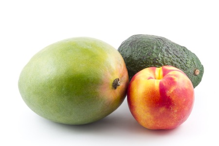 An avocado mango and nectarine all isolated on whiteの写真素材