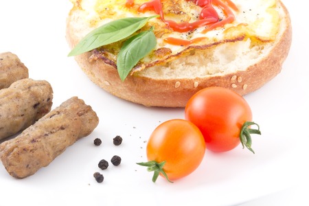 Yummy healthy breakfast bagel with sausage links and cherry tomatoesの写真素材