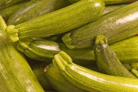 Organic farmers market green zucchini closeup for use as healthy eating backgroundの写真素材