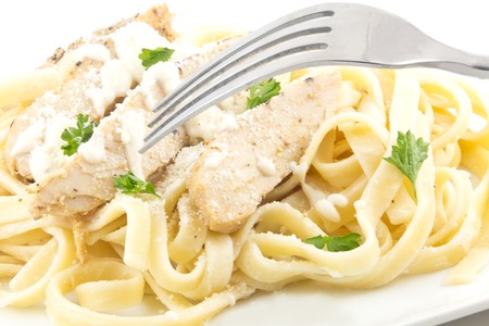 Chicken Fettuccini alfredo with fresh curly parsleyの写真素材