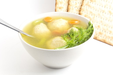 Delicious Matzoh ball soup with crackers wine and dillの写真素材
