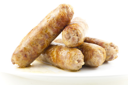 Cooked fried Italian sausage links isolated on whiteの写真素材
