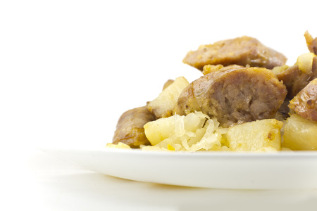 Chopped sausage with potatoes and sauerkraut ready to be eatenの写真素材
