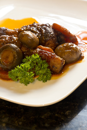 French cuisine, Coq Au Vin, crimini mushrooms, carrots, with wine sauce French cuisine, Coq Au Vin, crimini mushrooms, carrots, with wine sauce