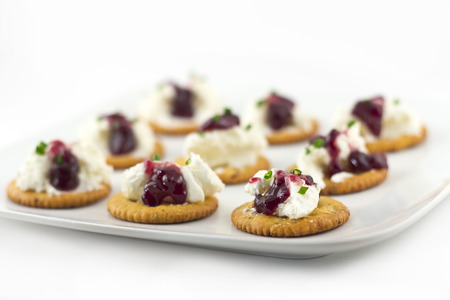 Snack plate of crackers topped with whipped cream cheese and grape Jellyの写真素材
