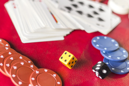 Rolling the dice in crowded gambling themed background, red for warning of addictionの写真素材
