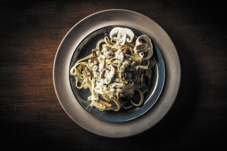 Fancy organic fetuccine pasta with creamy alfredo mushroom sauceの写真素材