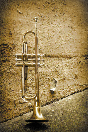 Old worn trumpet stands alone in alleyway behind a jazz clubの写真素材