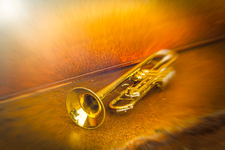 Old worn trumpet stands alone against a grungy wall outside a jazz clubの写真素材