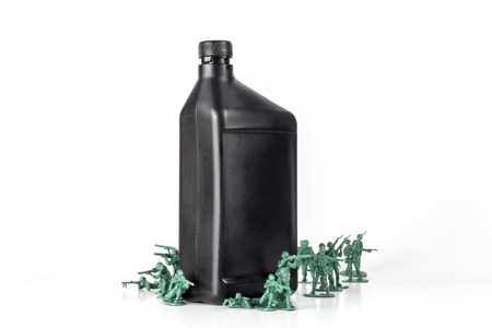 Toy army men with quart of oil symbolizing oil war in Middle Eastの写真素材
