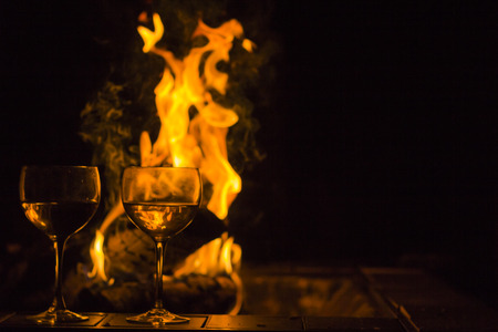 Two wineglasses by the campfire in this picturesque romantic sceneの写真素材