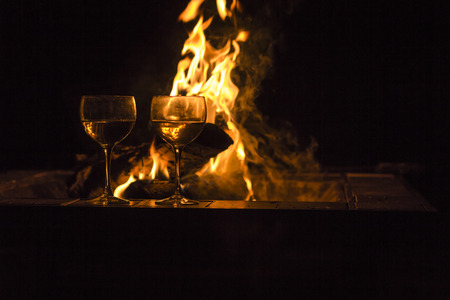 Two wineglasses by the campfire in this picturesque romantic sceneの写真素材
