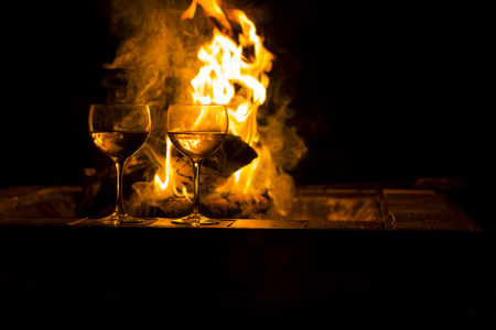 Two wineglasses by the campfire in this picturesque romantic sceneの写真素材