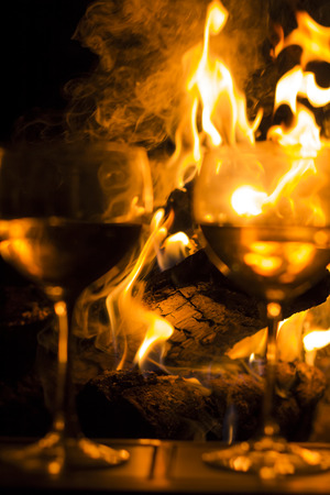 Two wineglasses by the campfire in this picturesque romantic sceneの写真素材