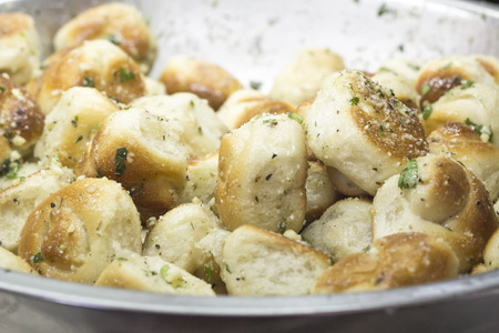 Fresh baked garlic knots tossed with Italian herbsの写真素材