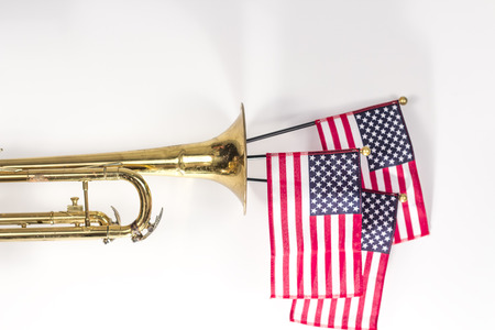 Three American Flags erupt from the bell of a trumpet in patriotism imageの写真素材