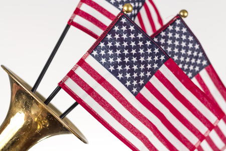 Three American Flags erupt from the bell of a trumpet in patriotism imageの写真素材