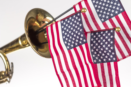 Three American Flags erupt from the bell of a trumpet in patriotism imageの写真素材