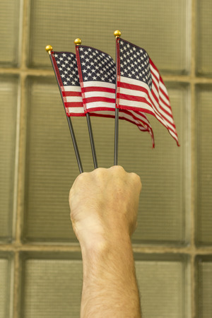 Waving three American flags in support the United States and freedomの写真素材
